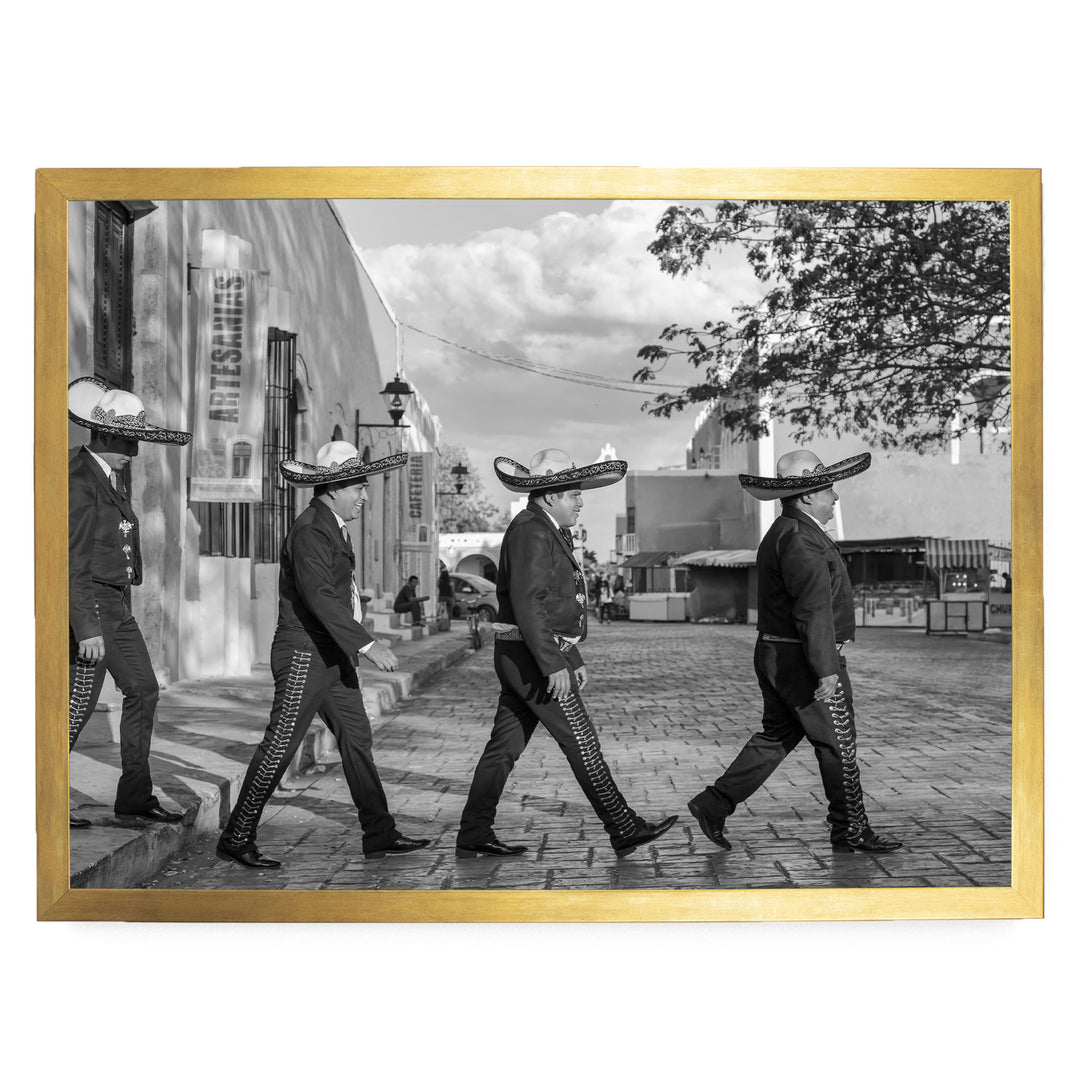 A group of men wearing sombreros walking down a street in a city.
