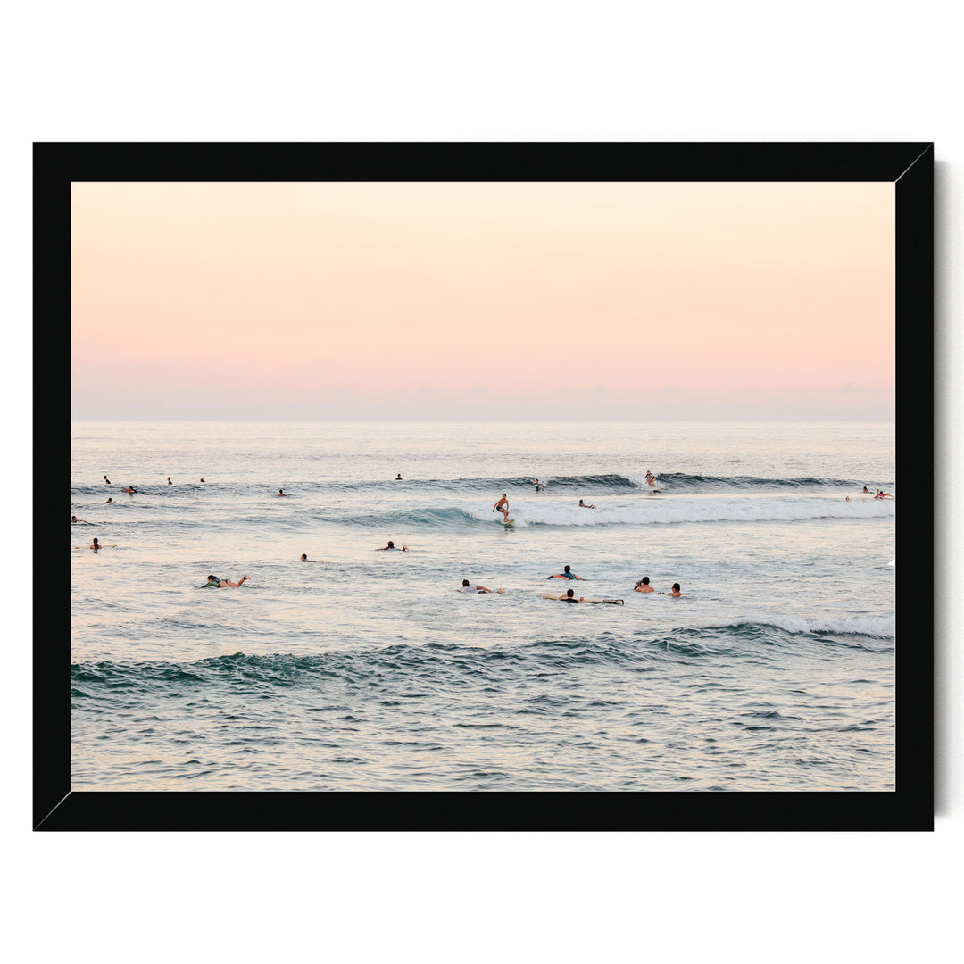 a group of people enjoying themselves in the ocean, with some of them riding waves on surfboards.