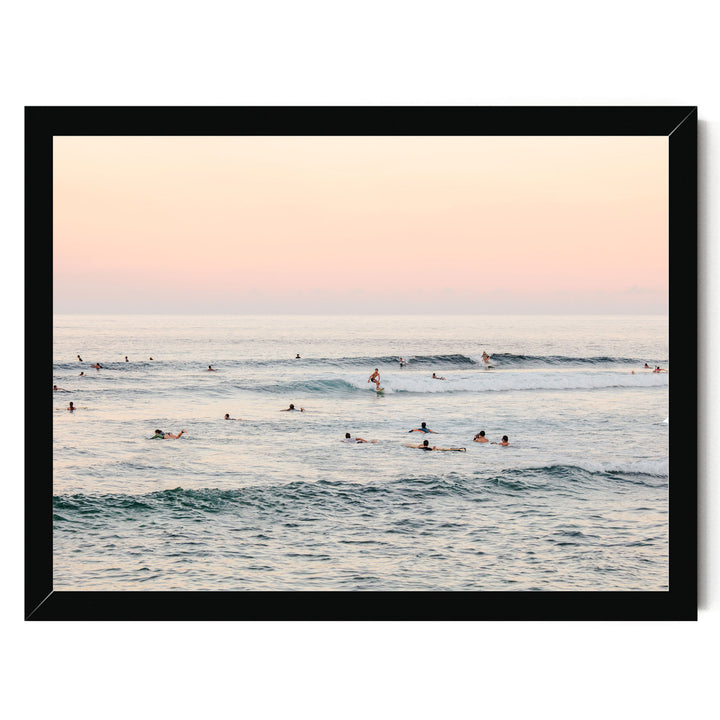 a group of people enjoying themselves in the ocean, with some of them riding waves on surfboards.