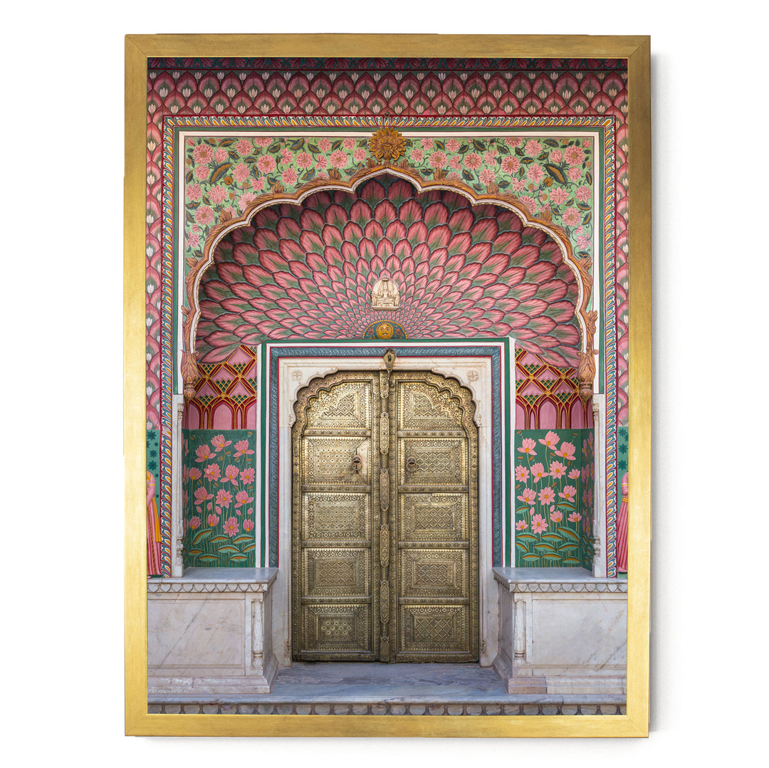 a beautifully decorated doorway with intricate patterns and vibrant colors, including pink, green, and gold elements.