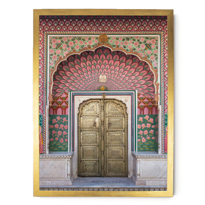 a beautifully decorated doorway with intricate patterns and vibrant colors, including pink, green, and gold elements.
