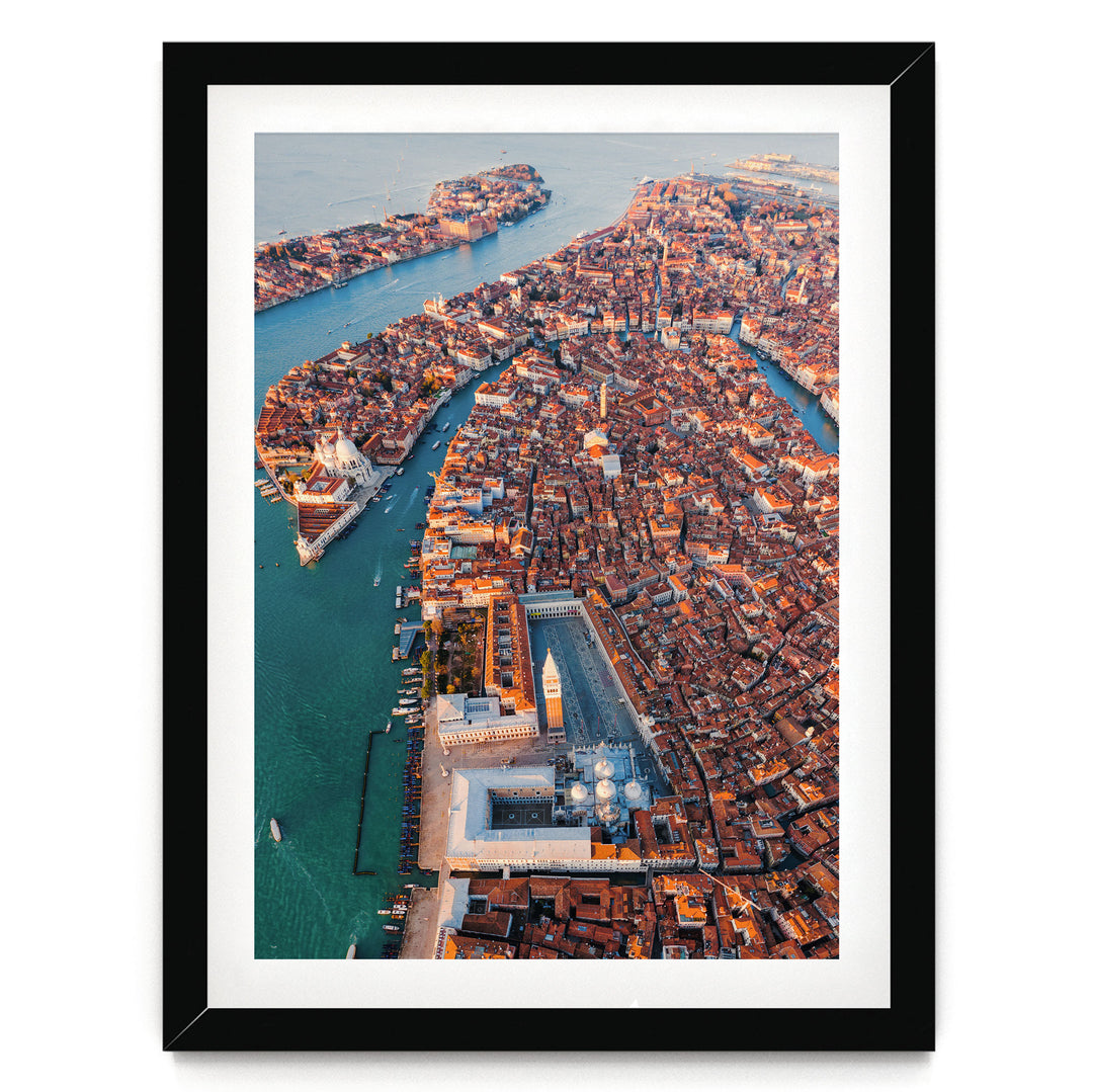 The image is an aerial view of a densely populated city with a river running through it. The city is filled with buildings and structures, creating a vibrant and bustling urban landscape.