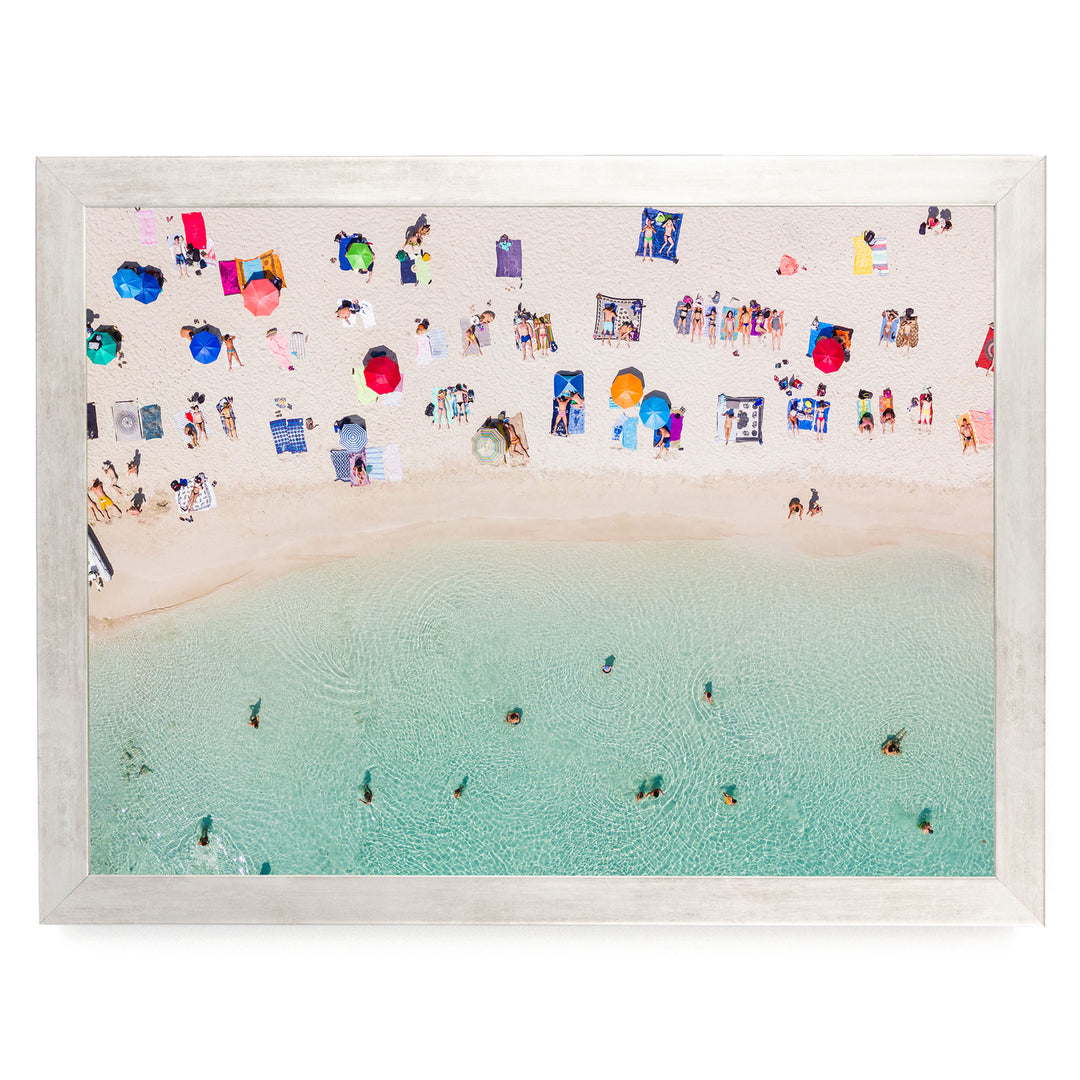 a crowded beach scene with numerous people enjoying the sun, sand, and water.
