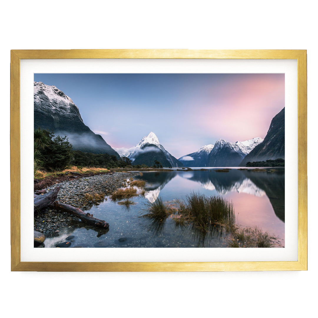 a serene mountain landscape with a calm lake reflecting the surrounding mountains and sky.