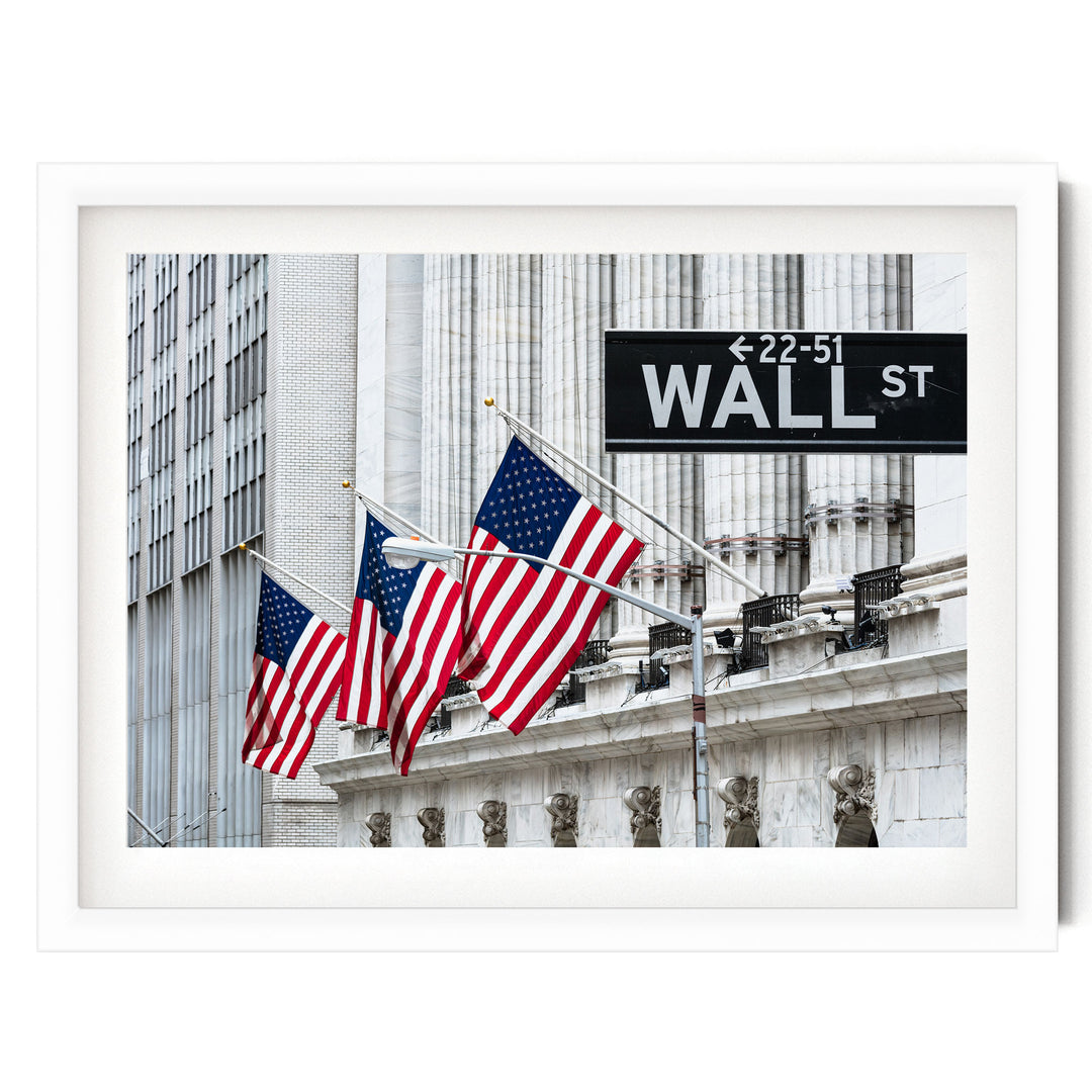 the iconic New York Stock Exchange building with three American flags flying in front of it, and a Wall Street sign indicating the direction to the 22nd Street Wall Street.