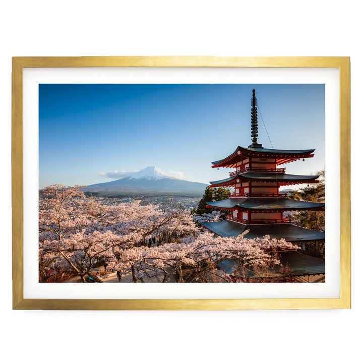 A framed photograph depicting a traditional Japanese pagoda overlooking a mountainous landscape with cherry blossoms in full bloom.