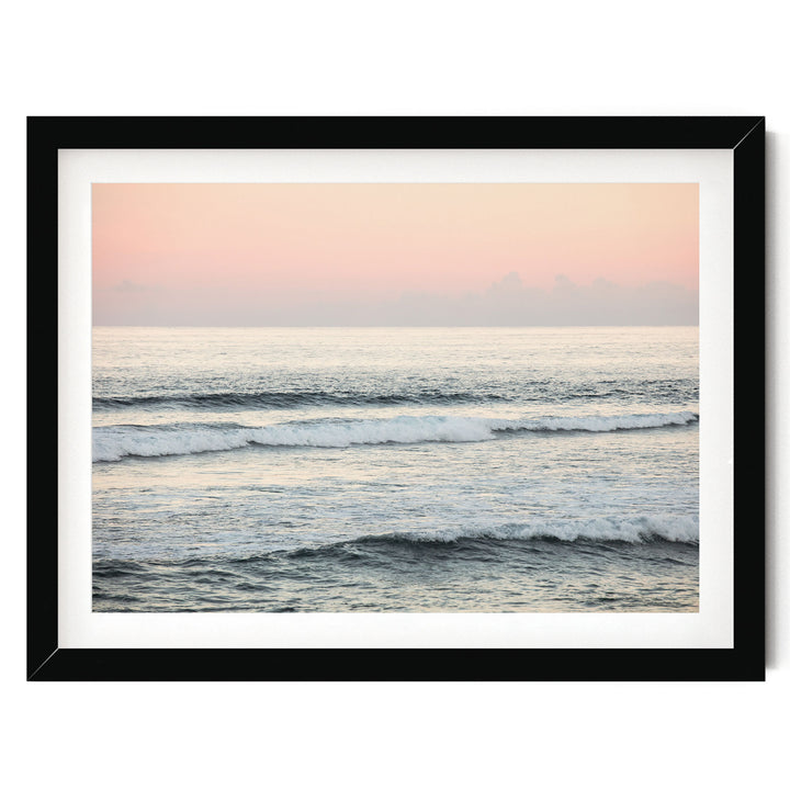 A serene ocean scene with waves gently lapping against the shore, framed in a black frame.