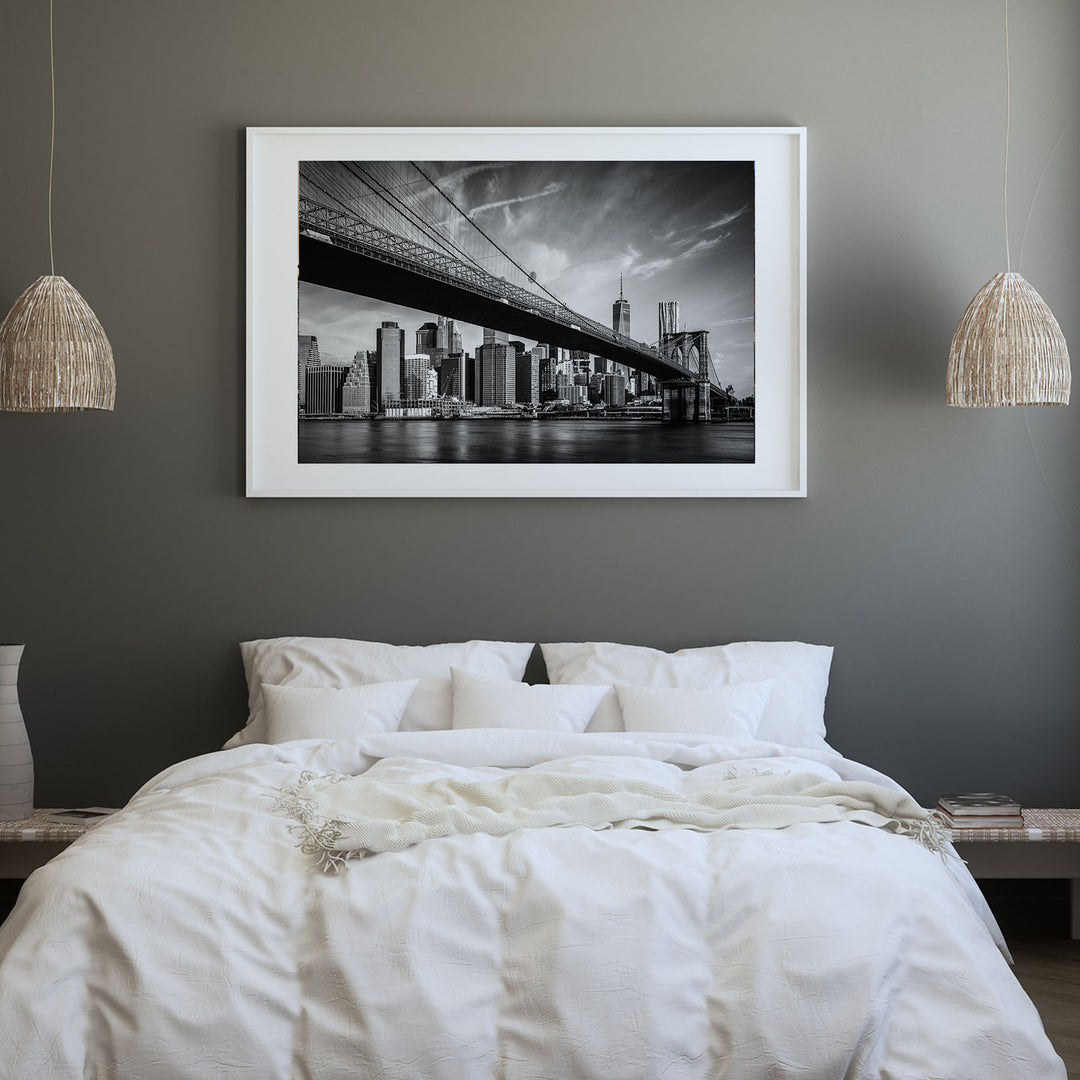 a picture of a bed with a picture hanging above it