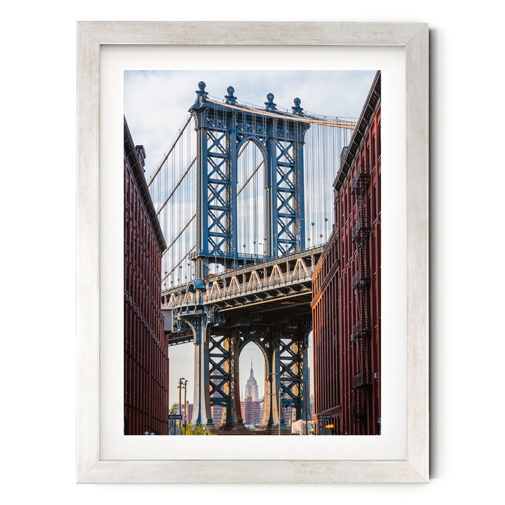 a large suspension bridge with multiple towers and cables, spanning across a river or valley. The bridge is surrounded by tall buildings, creating a striking contrast between the architectural structures and the natural landscape.