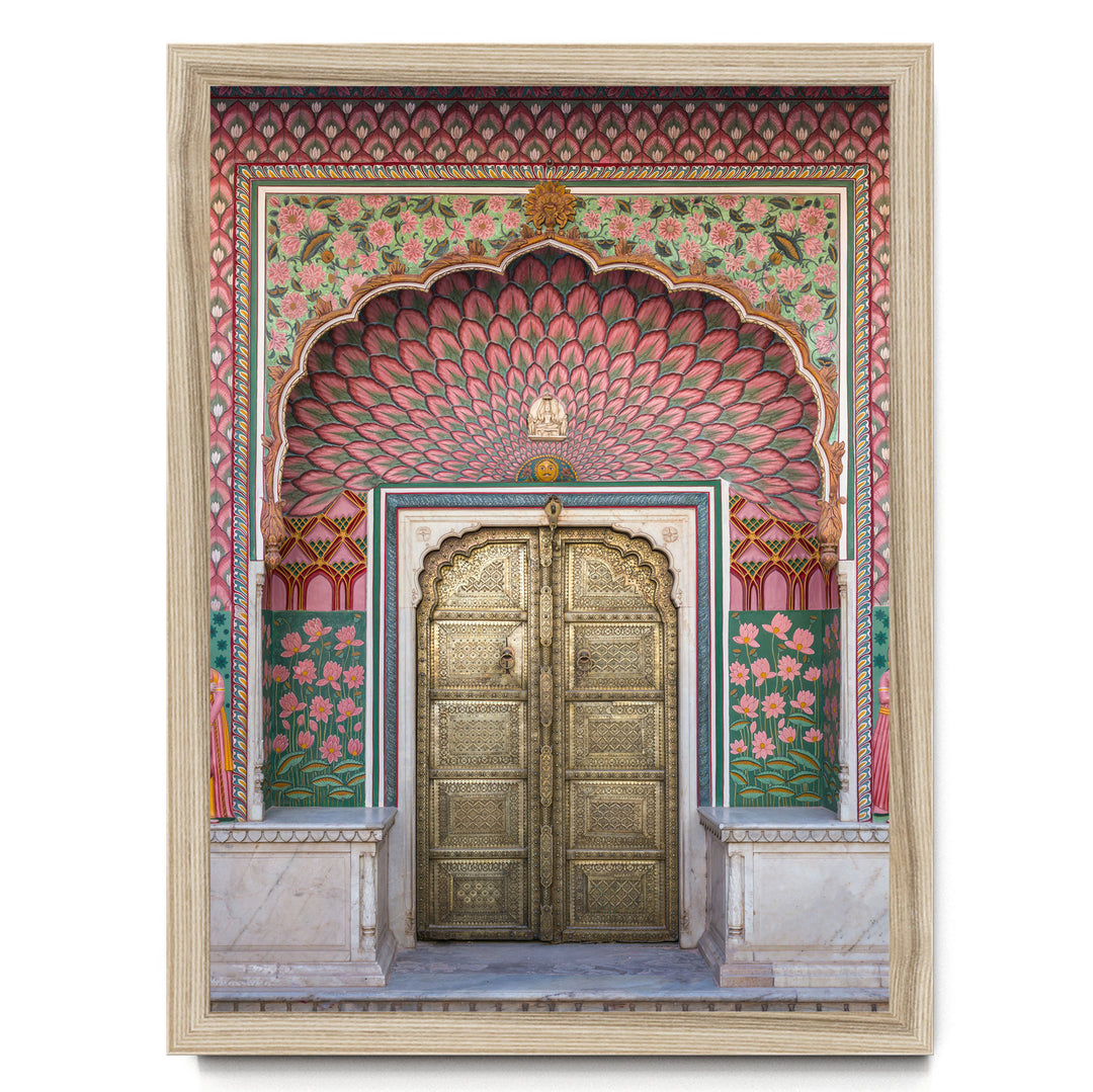 a beautifully decorated doorway with intricate patterns and vibrant colors, including pink, green, and gold elements.