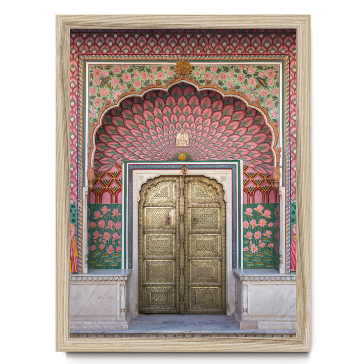 a beautifully decorated doorway with intricate patterns and vibrant colors, including pink, green, and gold elements.