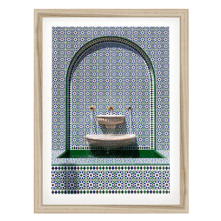 a decorative fountain with a mosaic tile pattern surrounding it.