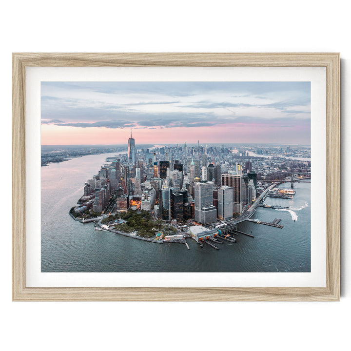 The image is an aerial view of the New York City skyline, showcasing the city's iconic skyscrapers and waterfront.
