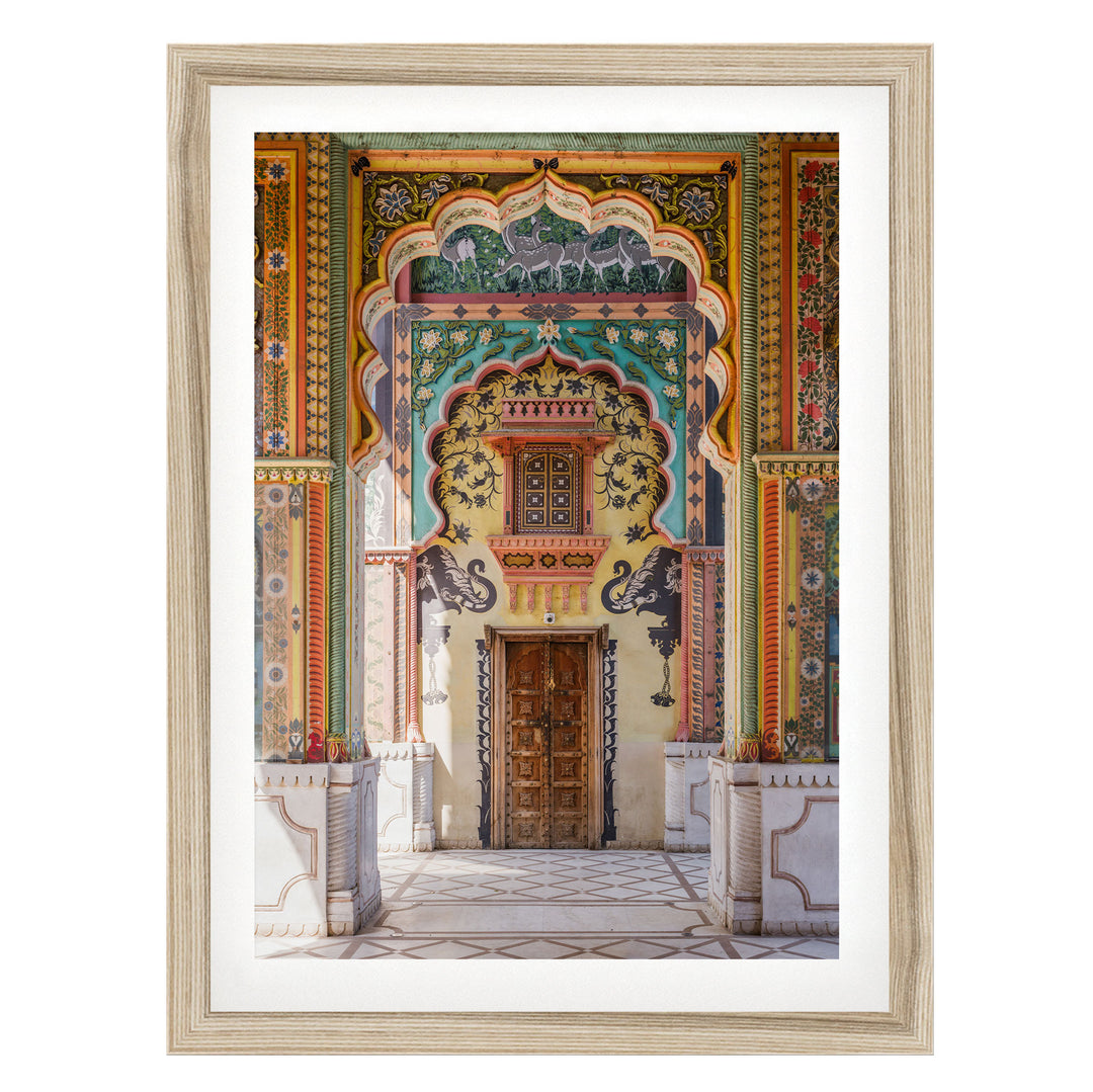 a colorful and ornate doorway with intricate patterns and designs, including arches, columns, and a wooden door.