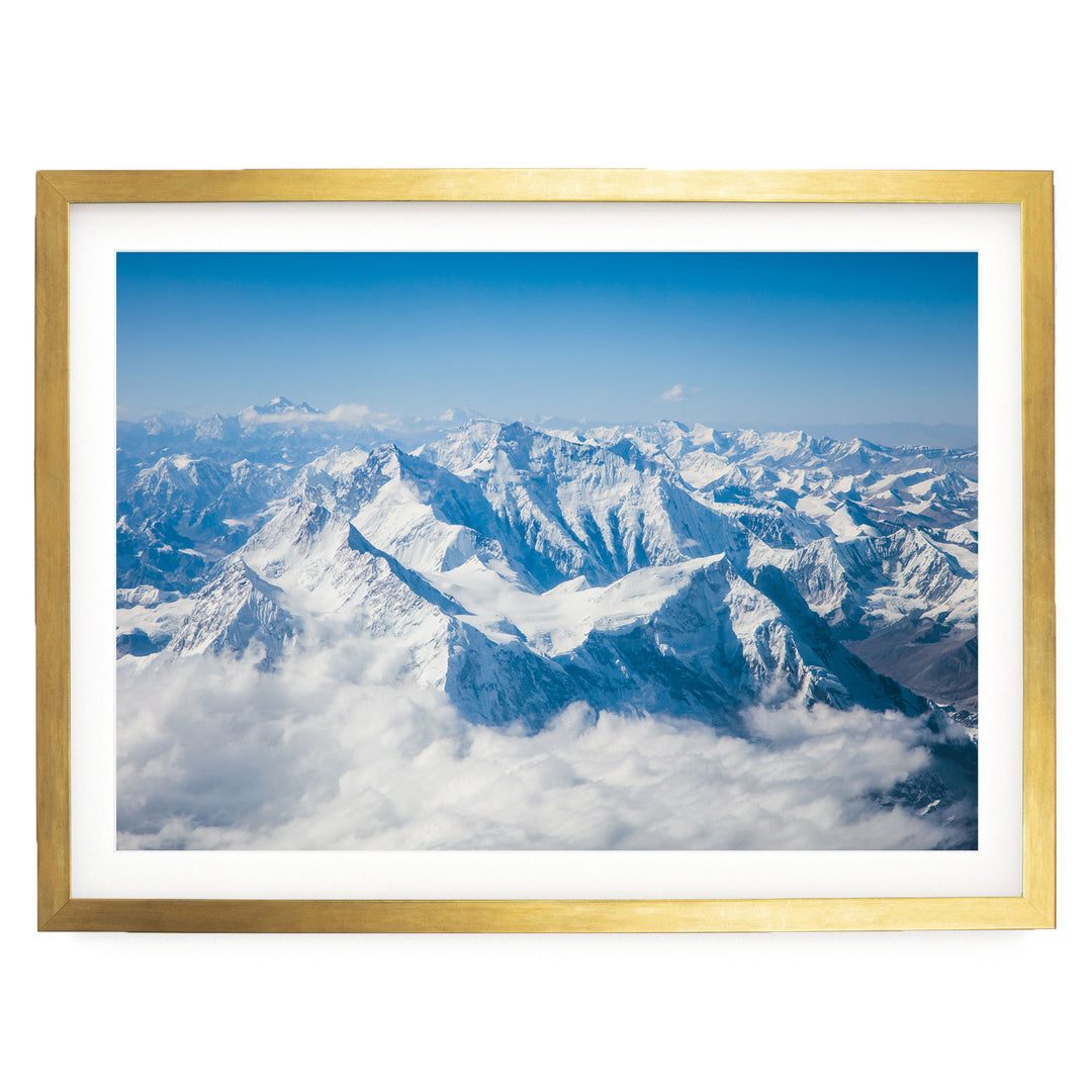 a breathtaking view of snow-capped mountains rising above a vast expanse of clouds, creating a stunning natural landscape.