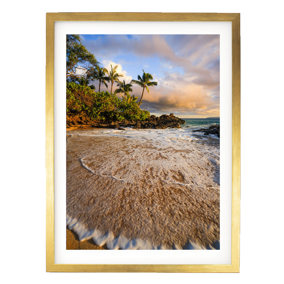 a serene beach scene with palm trees, a rocky shoreline, and crashing waves.