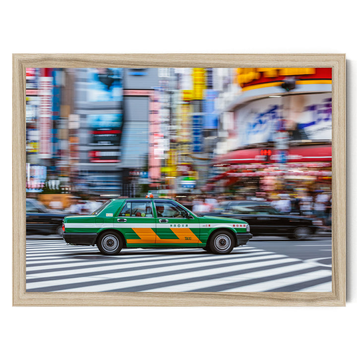 A green taxi cab is driving through a busy city street with colorful buildings and pedestrians in the background.