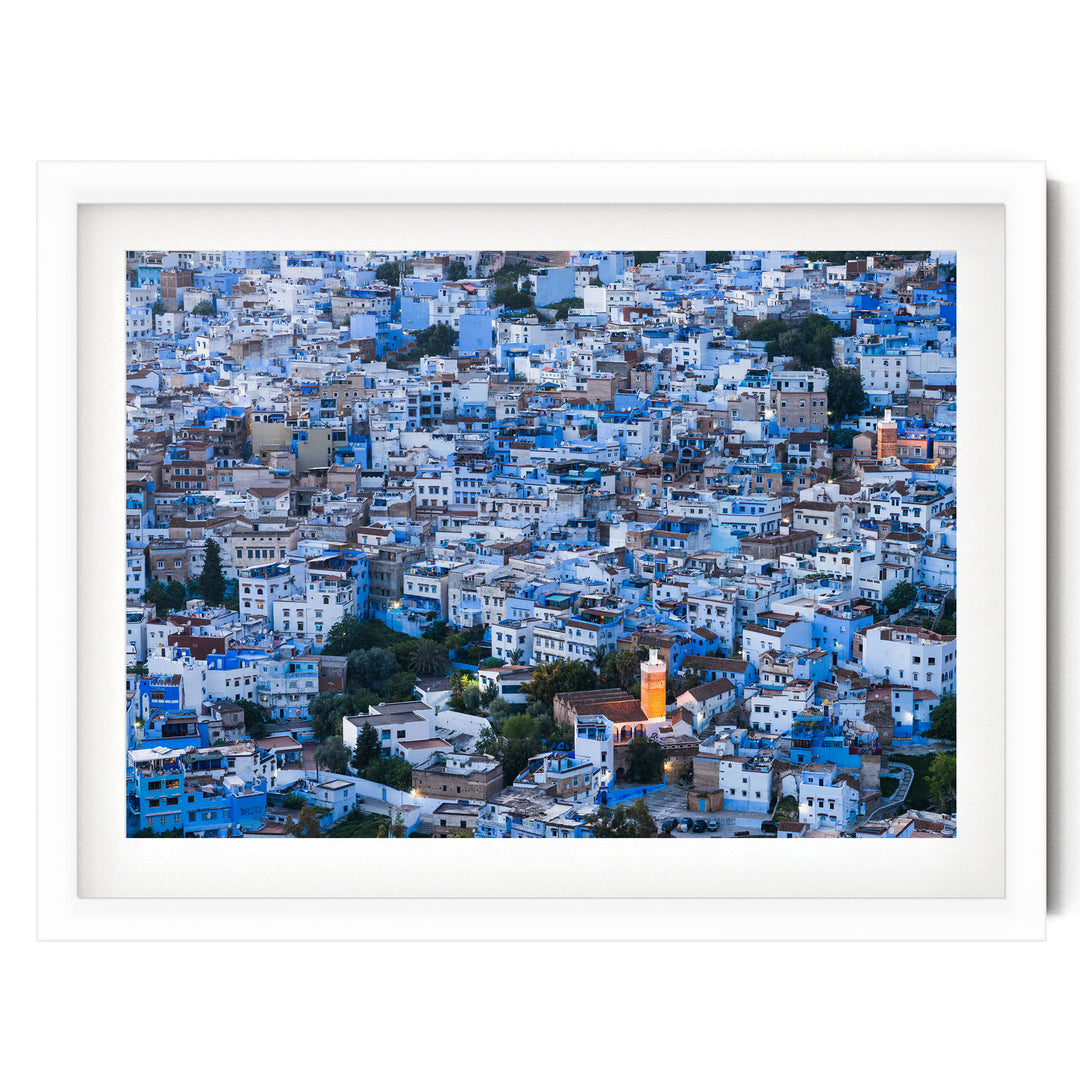 a densely packed cityscape with numerous buildings painted in shades of blue and white, creating a visually striking and vibrant urban landscape.