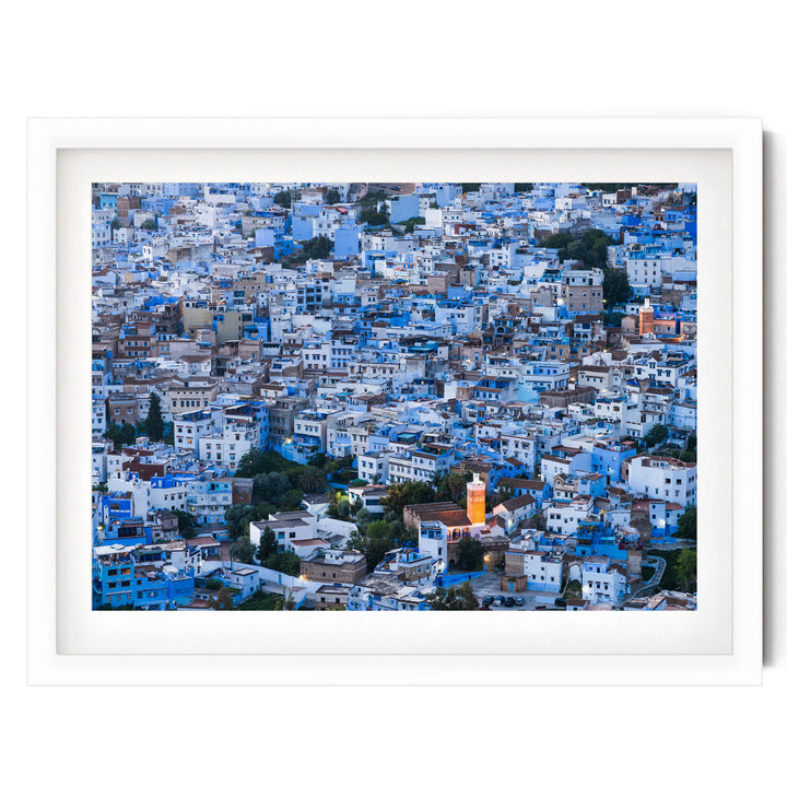 a densely packed cityscape with numerous buildings painted in shades of blue and white, creating a visually striking and vibrant urban landscape.