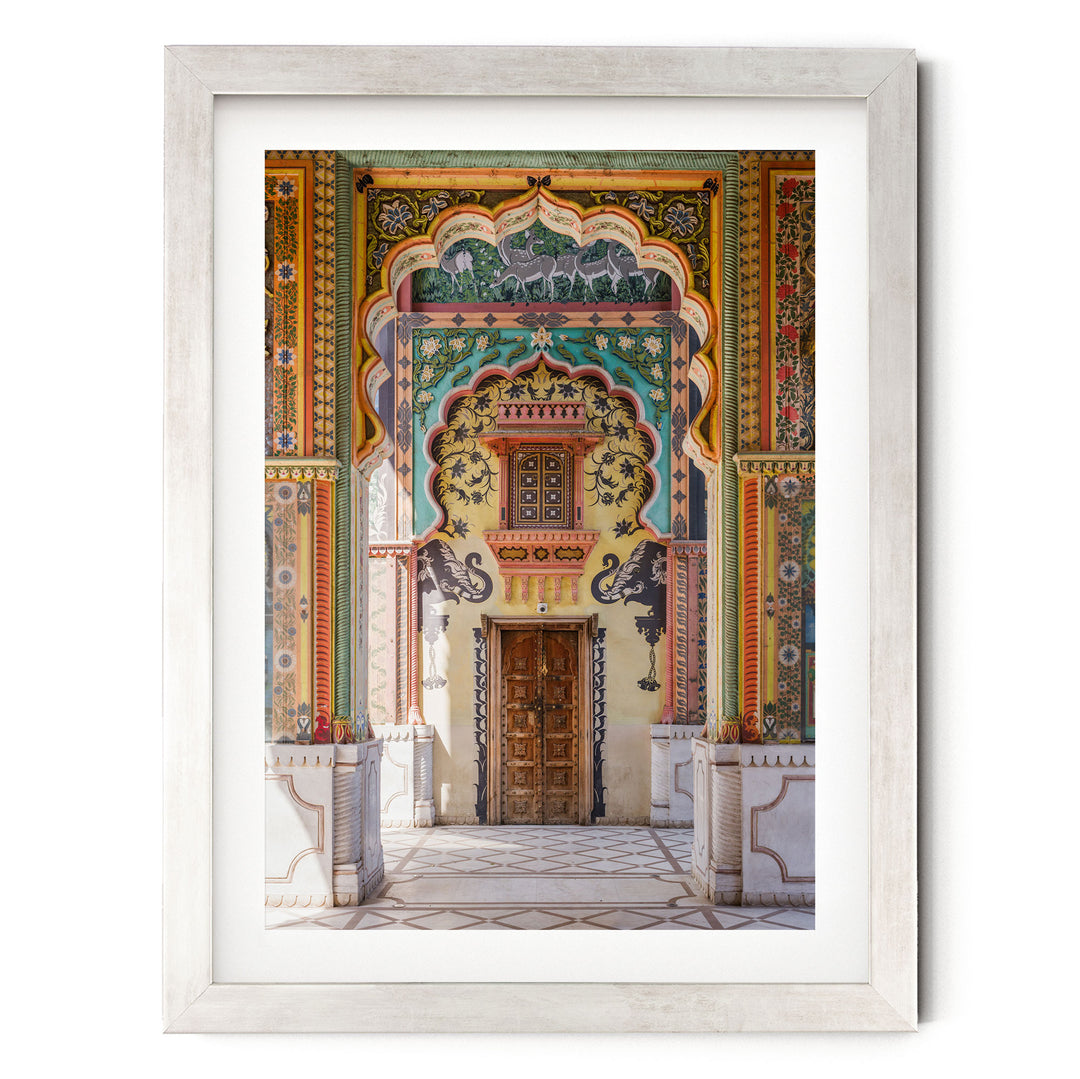 a colorful and ornate doorway with intricate patterns and designs, including arches, columns, and a wooden door.