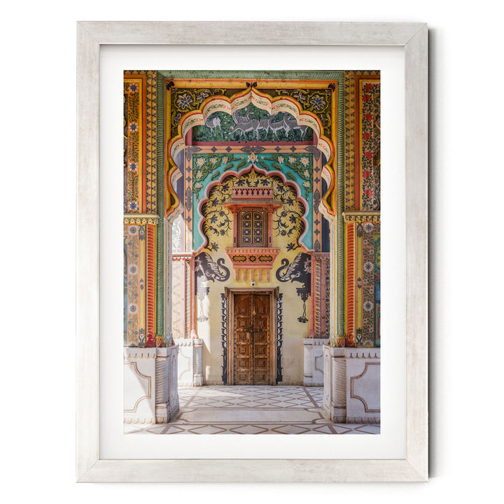 a colorful and ornate doorway with intricate patterns and designs, including arches, columns, and a wooden door.