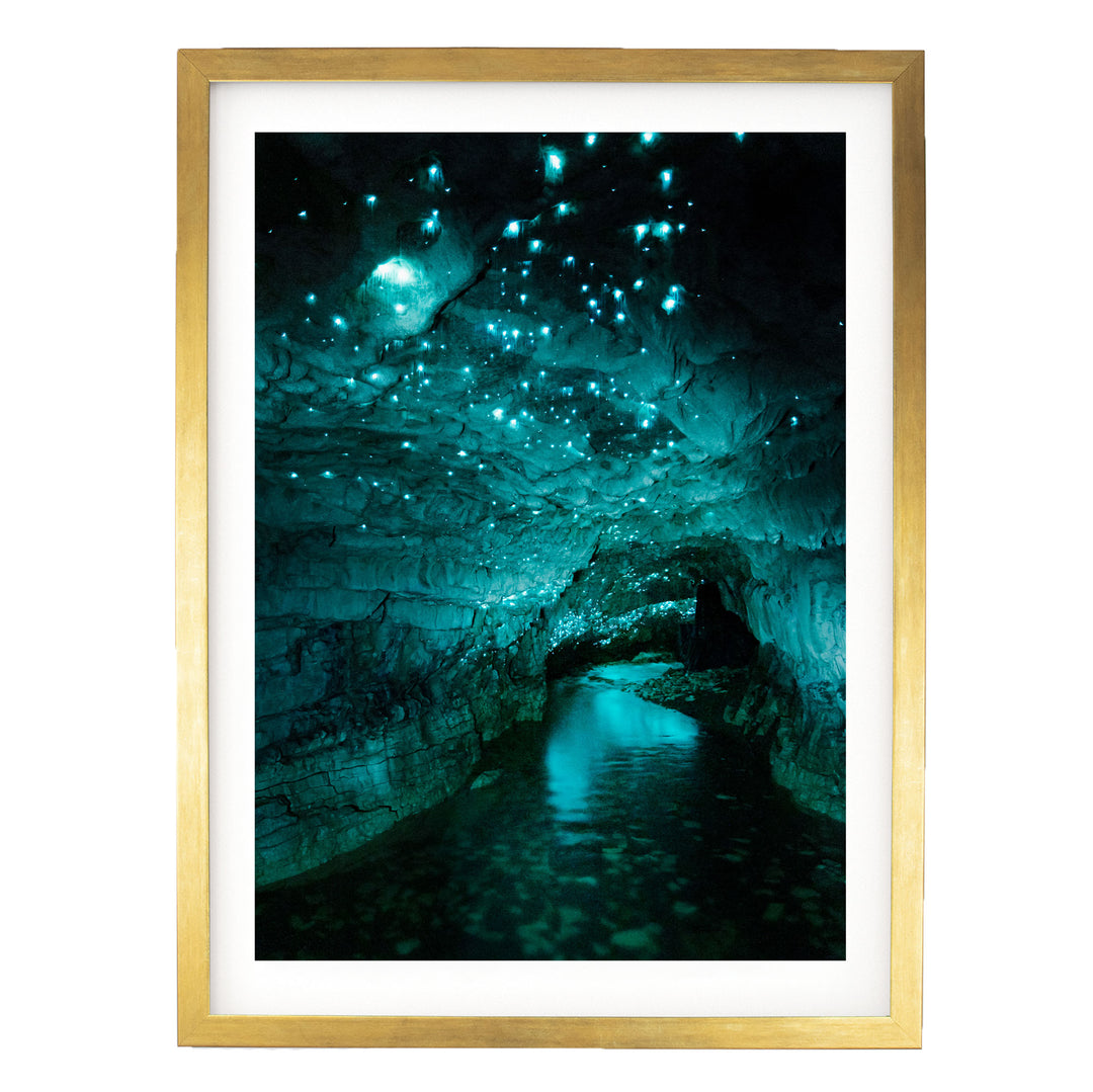 a cave with a stream of water flowing through it, creating a mesmerizing display of blue and green lights.