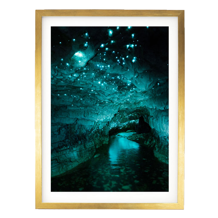 a cave with a stream of water flowing through it, creating a mesmerizing display of blue and green lights.