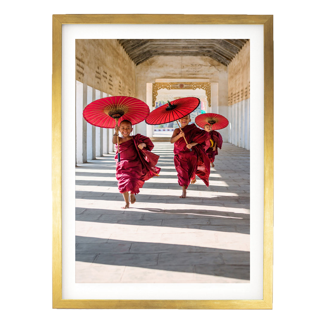 A group of people wearing red robes and carrying red umbrellas are walking down a hallway with a high ceiling and arched doorways.