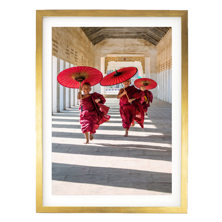 A group of people wearing red robes and carrying red umbrellas are walking down a hallway with a high ceiling and arched doorways.