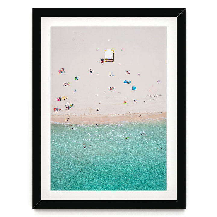 a beach scene with people enjoying the sun and water, featuring a clear turquoise ocean and a sandy beach.