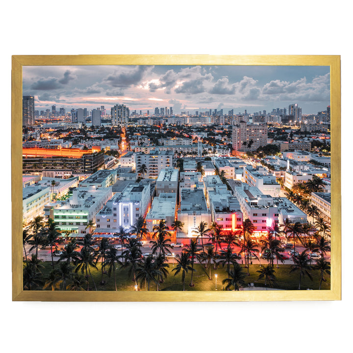 a vibrant cityscape at night, with a skyline of tall buildings and skyscrapers illuminated by colorful lights. Palm trees line the streets, adding a tropical touch to the urban landscape.