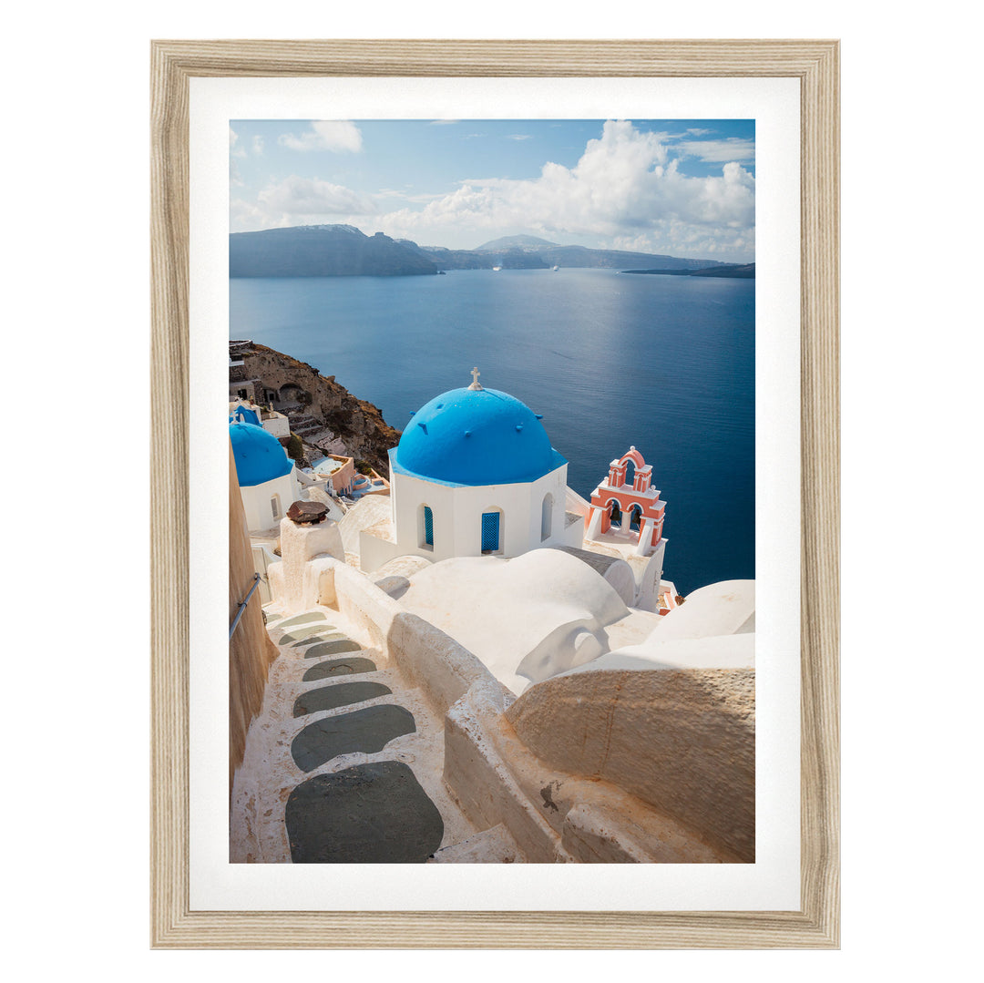 a picturesque view of the iconic blue domes and white buildings of Santorini, Greece, overlooking the stunning blue waters of the Aegean Sea.