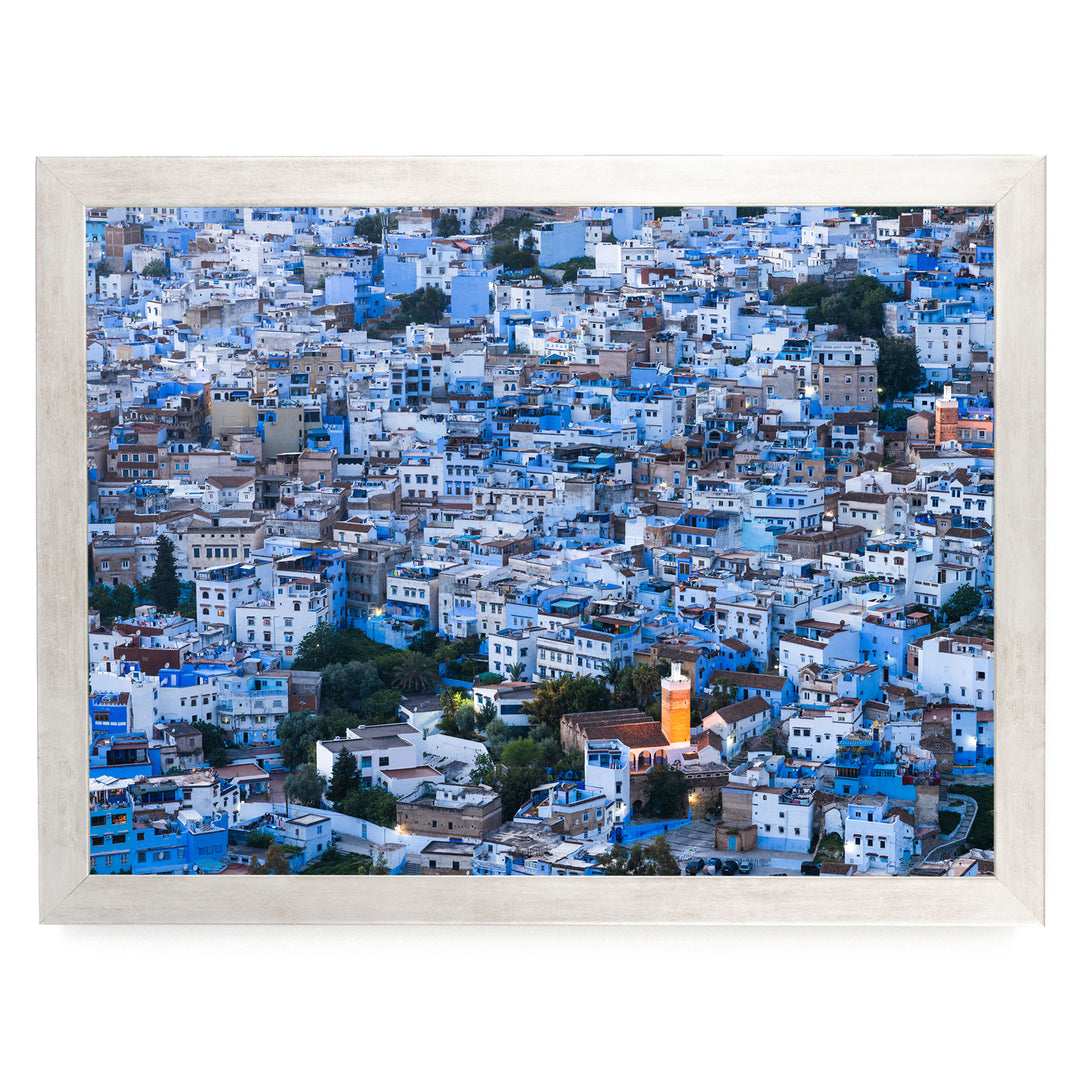a densely packed cityscape with numerous buildings painted in shades of blue and white, creating a visually striking and vibrant scene.