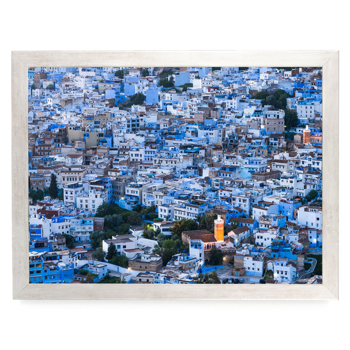 a densely packed cityscape with numerous buildings painted in shades of blue and white, creating a visually striking and vibrant scene.