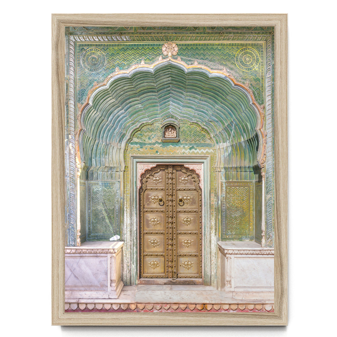 a large, ornate golden door with intricate carvings and patterns, set within an elaborate archway.