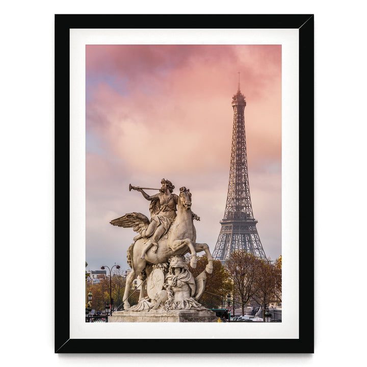 a statue of a winged man riding a rearing horse, with the Eiffel Tower visible in the background.