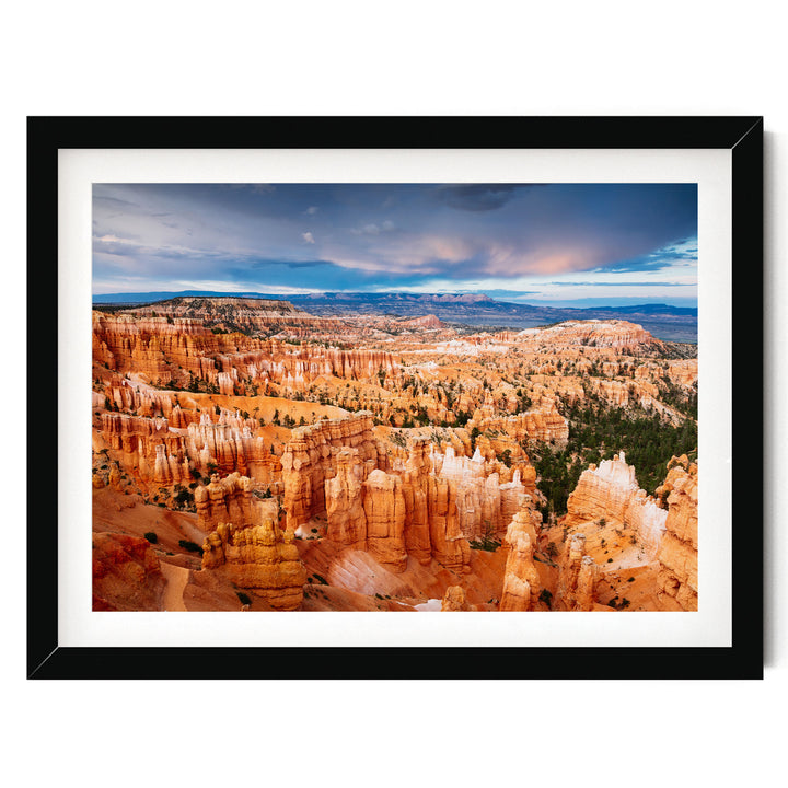 A framed photograph depicting the stunning natural landscape of Bryce Canyon National Park, with its iconic hoodoos and rock formations in a vibrant orange and red color palette.