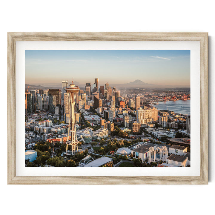The image is a framed aerial view of the Seattle skyline, showcasing the iconic Space Needle and surrounding buildings.