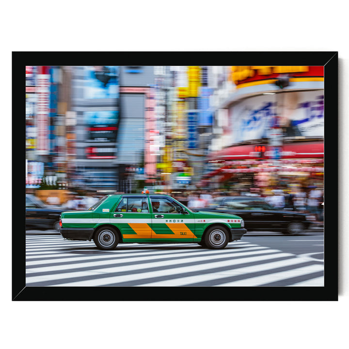 A green taxi cab is driving through a busy city street with colorful buildings and people in the background.