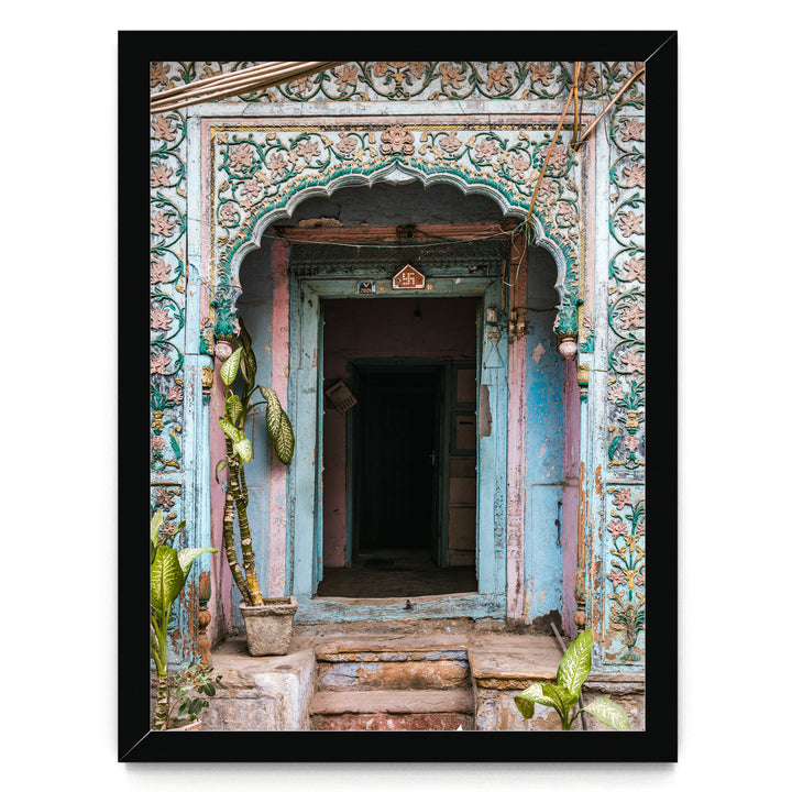 a colorful, ornately decorated doorway with a blue and pink color scheme, featuring intricate floral patterns and designs.