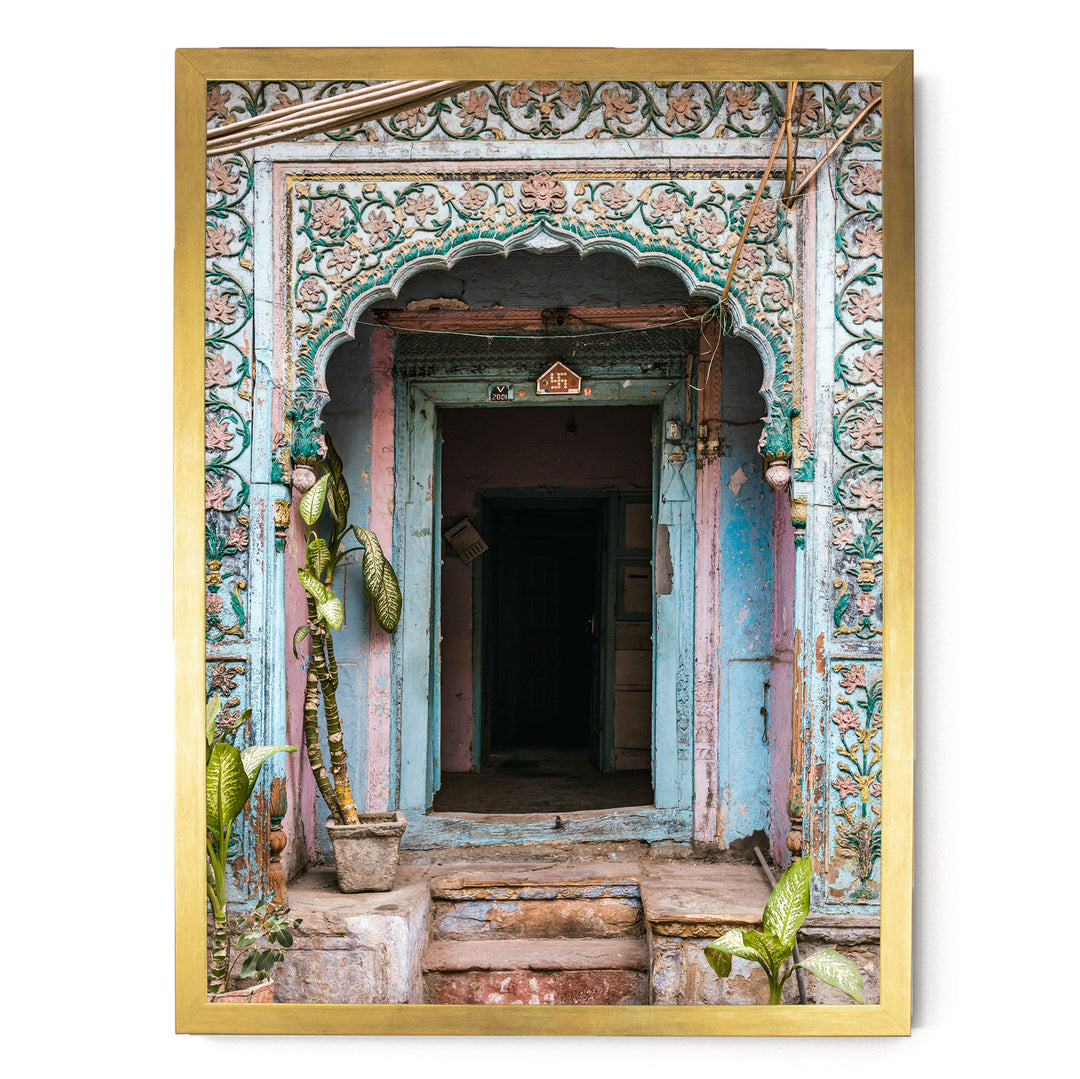 a colorful, ornately decorated doorway with a wooden frame, featuring intricate floral patterns and a small archway.