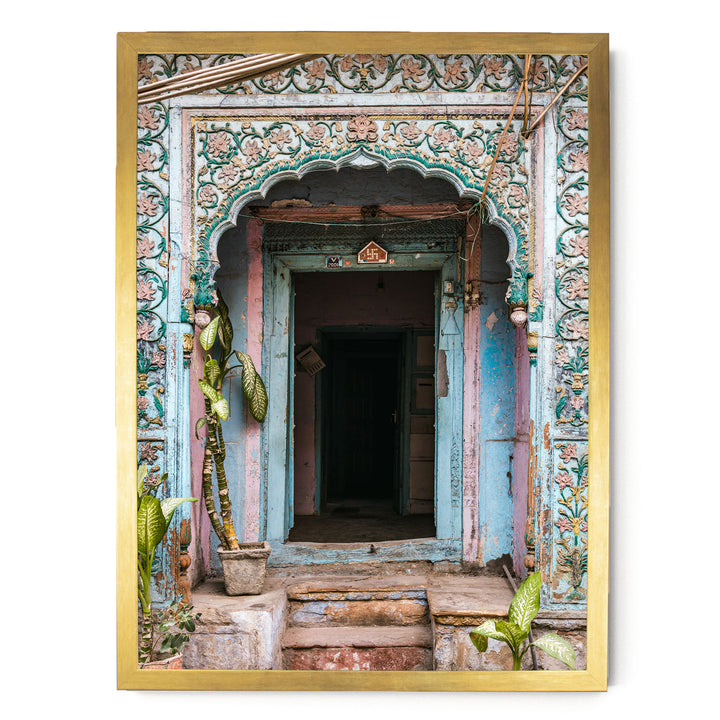 a colorful, ornately decorated doorway with a wooden frame, featuring intricate floral patterns and a small archway.