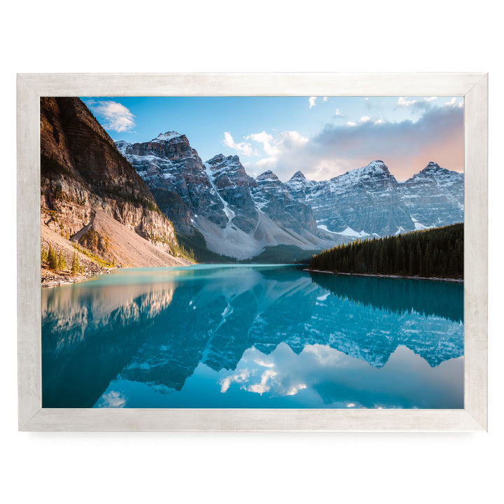 a serene mountain lake with a stunning reflection of the surrounding peaks and sky.