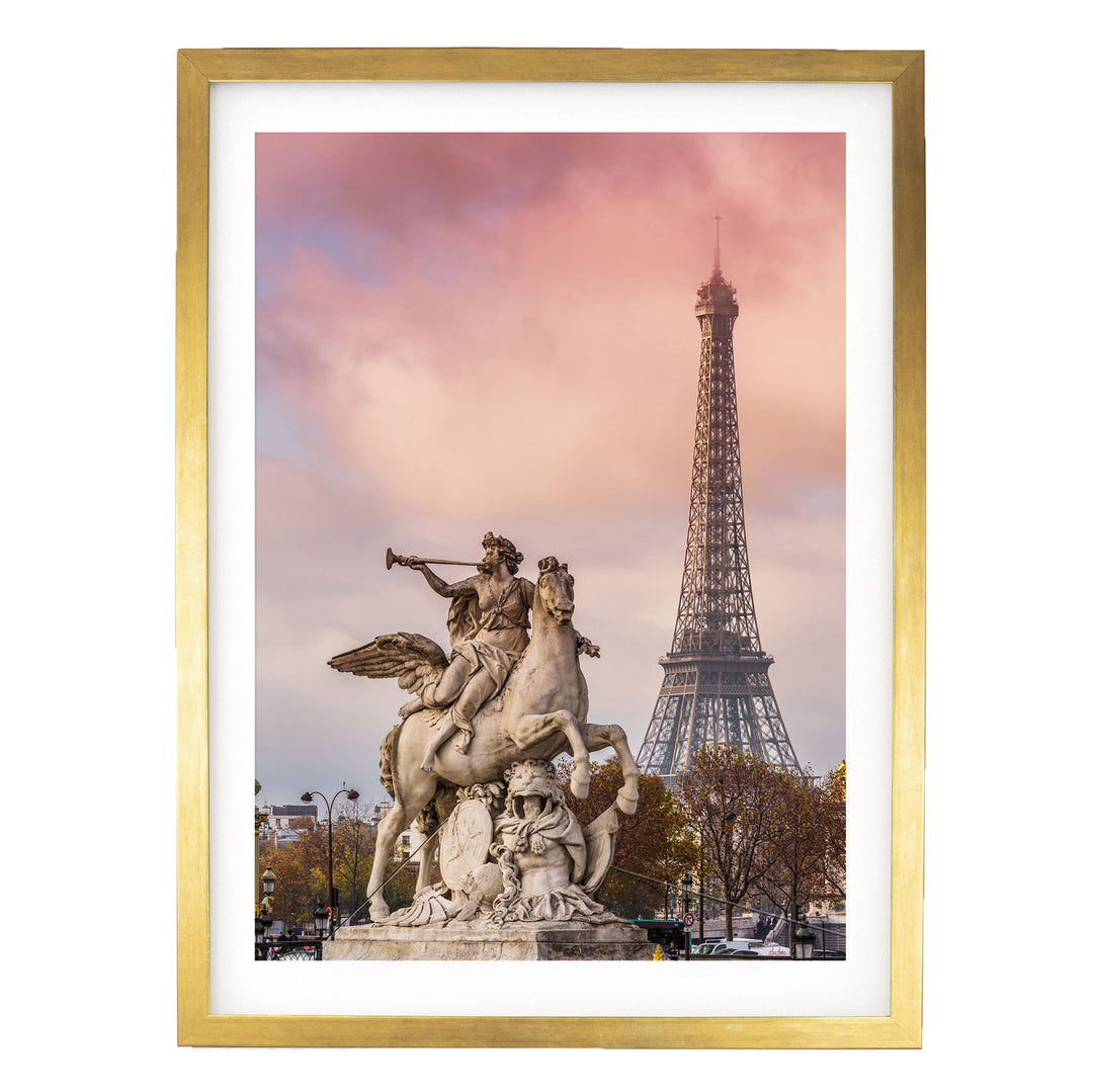 a large stone statue of a winged horseman with a trumpet, standing in front of the Eiffel Tower in Paris, France.