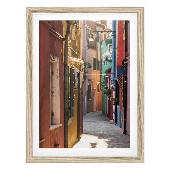 A narrow, colorful alleyway in a city, with buildings painted in various vibrant colors lining the street.