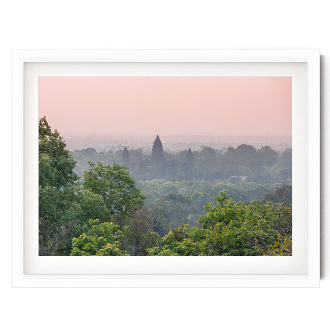 A serene landscape with a forested area and a temple in the distance, set against a pinkish-orange sky.