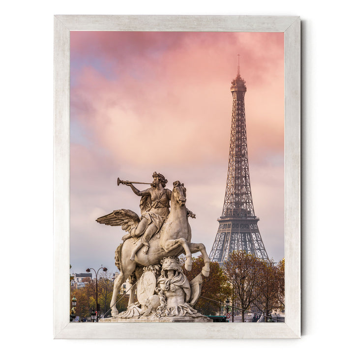 a large stone statue of a winged man riding a horse, with the Eiffel Tower visible in the background against a pink and purple sky.