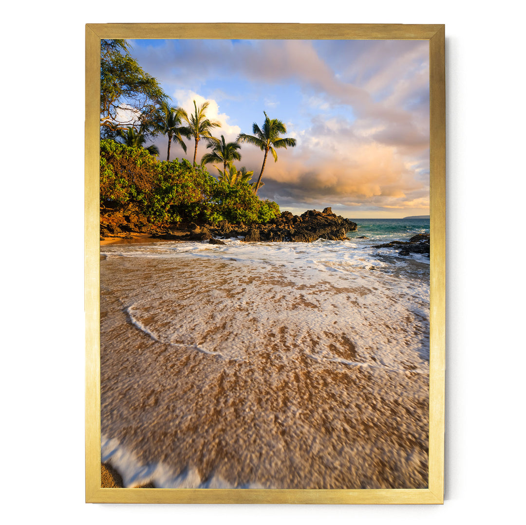 a serene beach scene with palm trees, a rocky outcropping, and crashing waves.