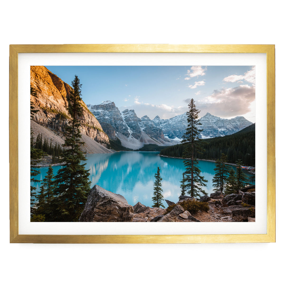 a serene mountain landscape with a stunning turquoise lake surrounded by snow-capped peaks and lush green forests.