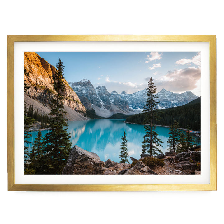 a serene mountain landscape with a stunning turquoise lake surrounded by snow-capped peaks and lush green forests.